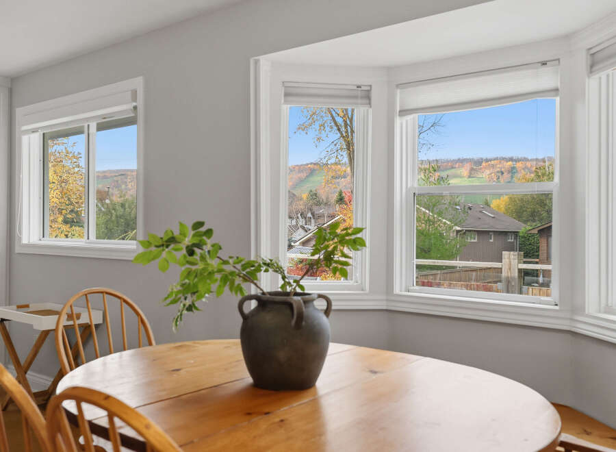 Enjoy breathtaking autumn views from this charming dining area, featuring a large bay window that floods the space with natural light.