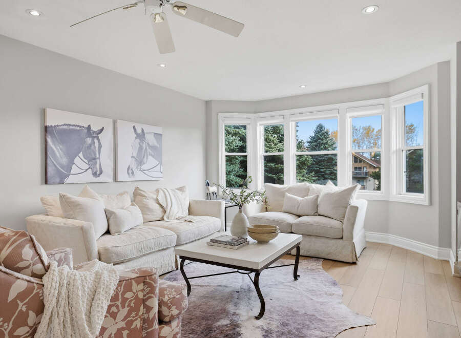 This inviting living room features a large, plush sectional sofa and a cozy armchair, perfect for relaxation.