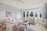 This inviting living room features a large, plush sectional sofa and a cozy armchair, perfect for relaxation.