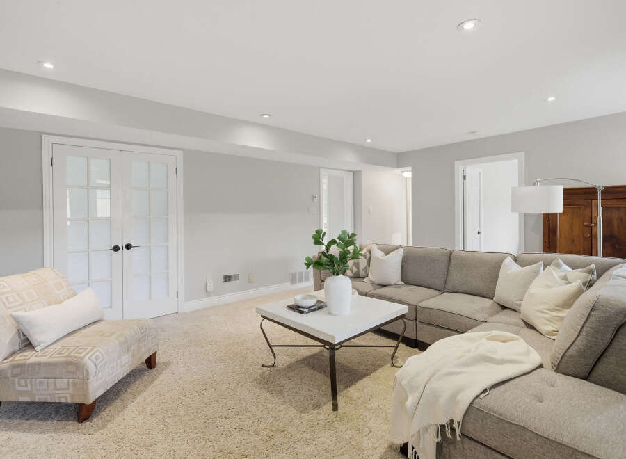 This inviting living room features a plush sectional sofa and a comfortable accent chair, perfect for relaxation.