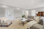 This inviting living room features a plush sectional sofa and a comfortable accent chair, perfect for relaxation.