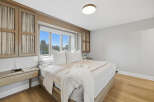 Experience luxurious comfort in this master bedroom, featuring a king-size bed adorned with plush white linens and decorative pillows.