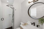 Experience modern comfort in this beautifully appointed bathroom, featuring a sleek walk-in shower with subway tile and a built-in niche.