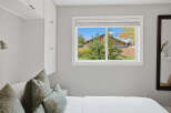This bedroom offers ample storage with built-in white cabinets, perfect for organizing your belongings.