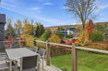 Enjoy breathtaking autumn views from this spacious deck, complete with a modern dining set perfect for al fresco meals.