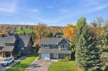 Experience the beauty of autumn from this stunning home, nestled against a backdrop of vibrant fall foliage and a ski hill.