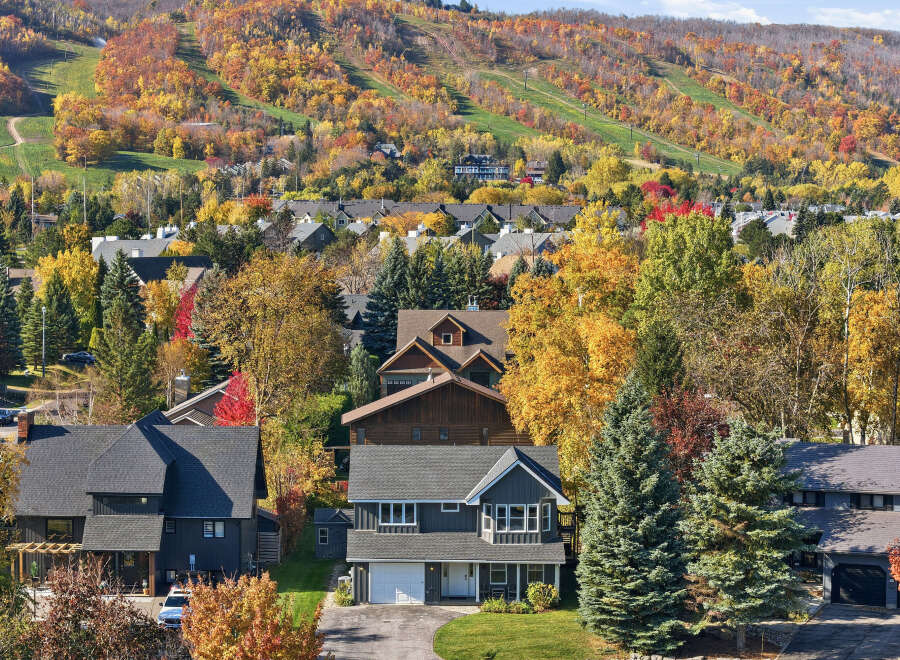 Experience the beauty of autumn from this stunning property nestled amidst vibrant fall foliage.
