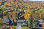 Experience the beauty of autumn from this stunning property nestled amidst vibrant fall foliage.