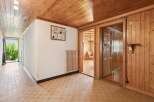 Step into a charming entryway featuring warm wooden ceilings and paneling, creating a cozy and inviting atmosphere.