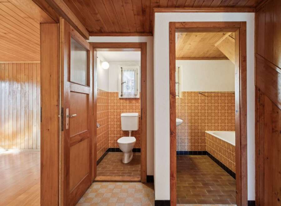 Step into a charming home featuring a rustic wooden interior with warm wood paneling and ceilings.