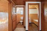 Step into a charming home featuring a rustic wooden interior with warm wood paneling and ceilings.