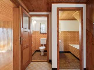 Step into a charming home featuring a rustic wooden interior with warm wood paneling and ceilings.