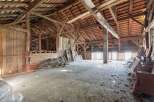 Explore the potential of this expansive barn, featuring a robust timber frame and a traditional tiled roof, offering a unique opportunity for renovation or conversion.