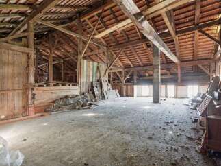 Explore the potential of this expansive barn, featuring a robust timber frame and a traditional tiled roof, offering a unique opportunity for renovation or conversion.