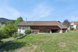 Discover this charming property featuring a spacious barn with traditional wooden doors, perfect for storage or potential conversion.