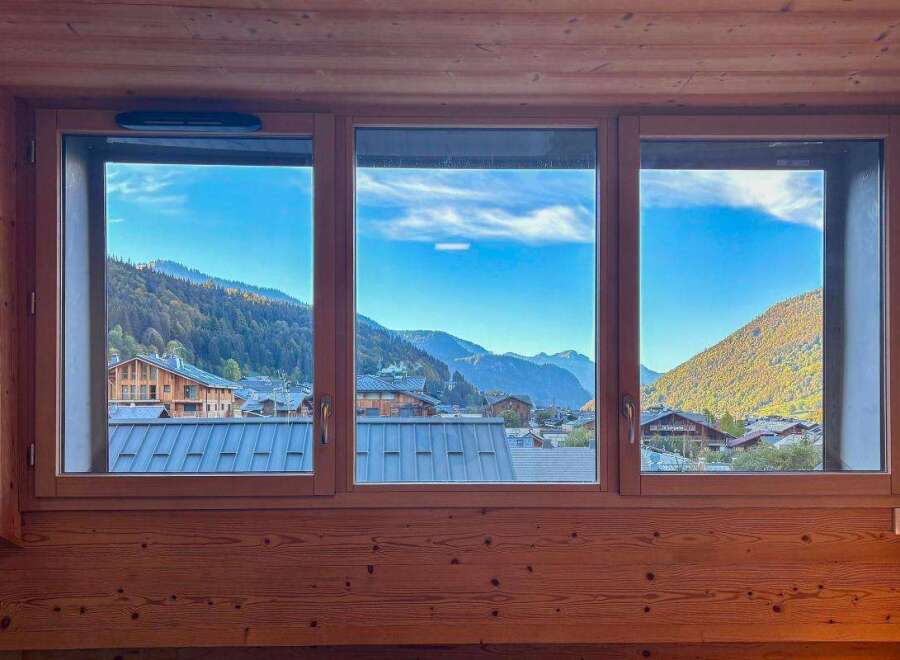 Experience breathtaking mountain views from this charming property, framed by a warm, wood-paneled interior.