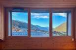 Experience breathtaking mountain views from this charming property, framed by a warm, wood-paneled interior.