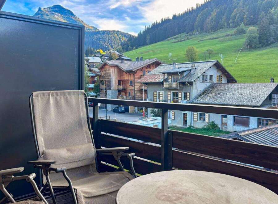 Enjoy breathtaking mountain views from this charming balcony, complete with comfortable seating and a table, perfect for morning coffee or evening relaxation.