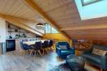 Experience luxurious mountain living in this stunning chalet, featuring a spacious dining area with a large wooden table and comfortable seating, perfect for gathering with loved ones.