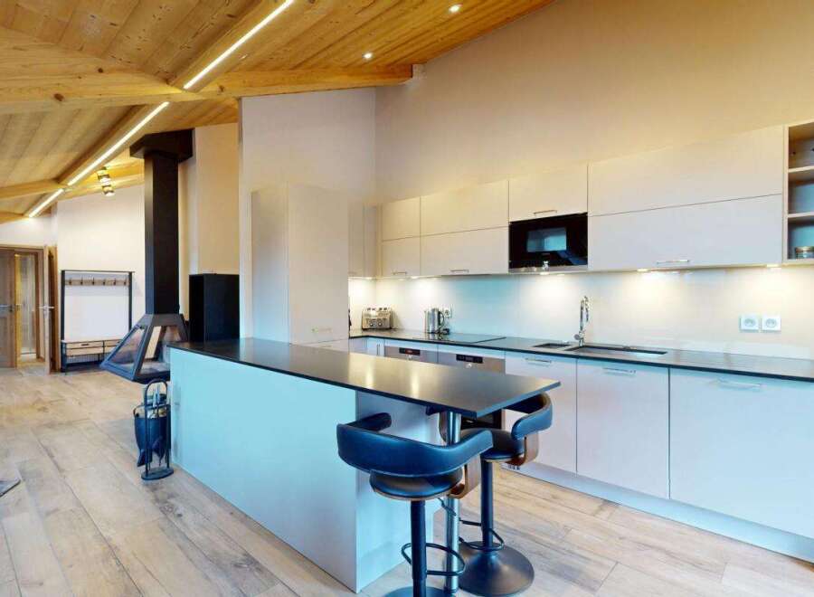 Experience modern living in this stunning open-plan space, featuring a sleek, contemporary kitchen with ample counter space and integrated appliances.