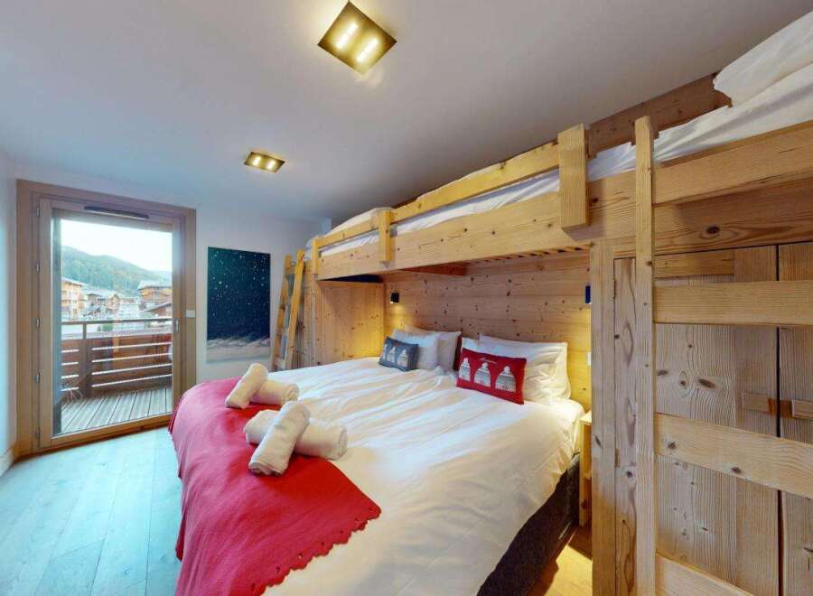 Experience ultimate comfort and style in this charming bedroom, featuring a cozy bunk bed setup perfect for families or groups.