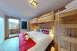 Experience ultimate comfort and style in this charming bedroom, featuring a cozy bunk bed setup perfect for families or groups.