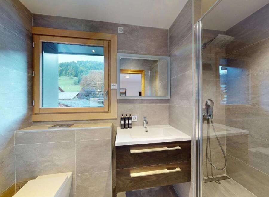 Experience modern comfort in this beautifully appointed bathroom, featuring a sleek vanity with ample storage and a spacious walk-in shower.