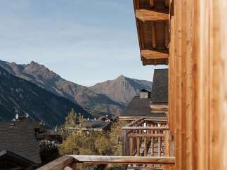 Experience breathtaking mountain views from the expansive wooden balconies of this charming alpine property.