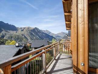 Enjoy breathtaking mountain views from this charming wooden balcony, perfect for your morning coffee or evening relaxation.