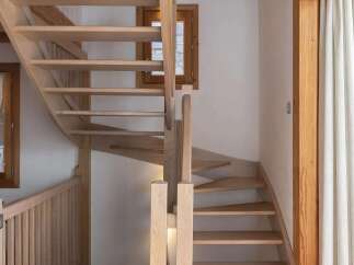 Ascend to the upper levels of this charming home via a beautifully crafted wooden staircase.