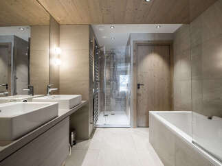 Experience modern luxury in this stunning bathroom, featuring a sleek double vanity with vessel sinks and contemporary chrome faucets.