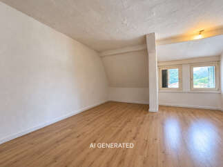 This spacious room features a light-colored, textured ceiling and walls, complemented by a warm, wood-look laminate floor.