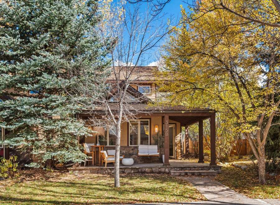Charming home with a welcoming covered porch, perfect for enjoying the crisp autumn air.