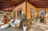 Enjoy the outdoors on this charming covered porch, complete with a comfortable swing and a cozy seating area.