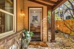 Welcome guests with a charming entryway featuring a 'Pray for Snow' sign and a beautiful floral arrangement.