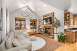 Experience cozy living in this inviting living room, featuring a stunning stone fireplace as the focal point.