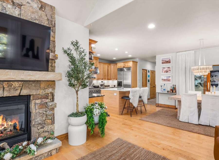 Cozy up by the stone fireplace in this inviting living space, perfect for relaxing evenings.