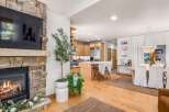 Cozy up by the stone fireplace in this inviting living space, perfect for relaxing evenings.