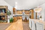 Experience the perfect blend of rustic charm and modern comfort in this inviting open-concept living and kitchen space.