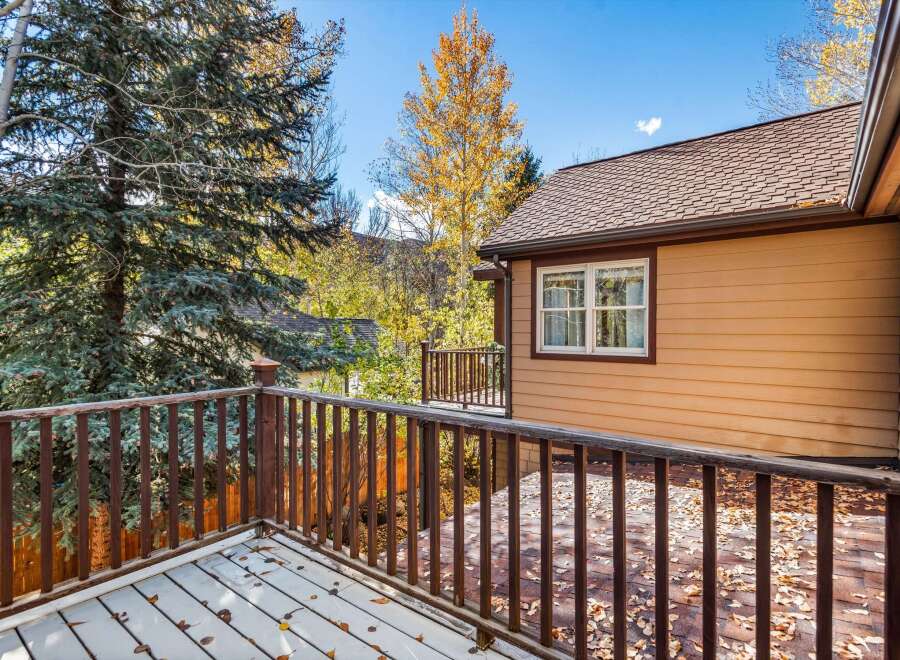 Enjoy the crisp autumn air from this charming deck, perfect for savoring your morning coffee or evening tea.