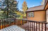 Enjoy the crisp autumn air from this charming deck, perfect for savoring your morning coffee or evening tea.