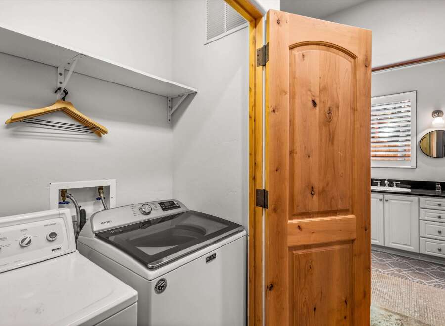 This laundry room features a Maytag washing machine and a dryer, ready for your household needs.