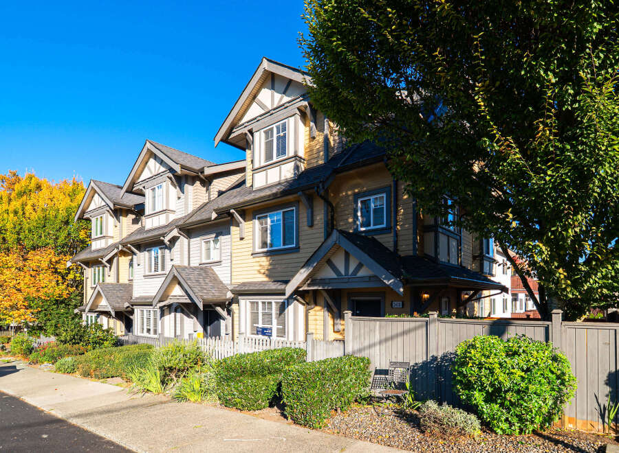 Discover charming townhomes with classic architectural details, featuring warm siding and contrasting trim.
