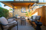 Enjoy outdoor living in this charming patio space, complete with comfortable seating and a modern coffee table.