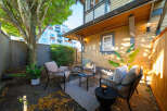 Enjoy your morning coffee or evening drinks in this charming backyard patio, complete with comfortable seating and a coffee table.