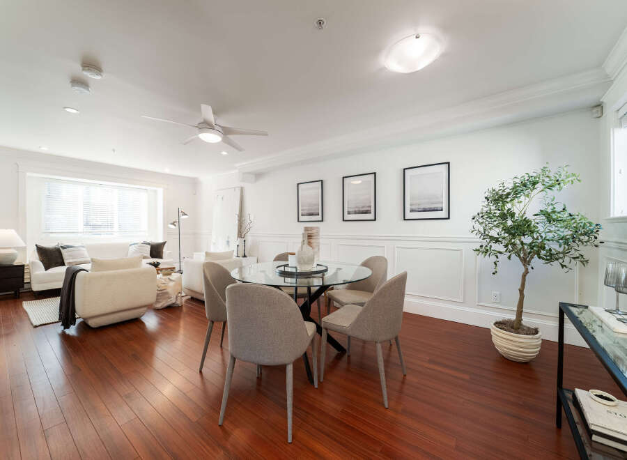 Experience elegant living in this beautifully appointed dining and living area, featuring a sleek glass-top dining table with upholstered chairs, perfect for intimate gatherings.