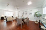 Experience elegant living in this beautifully appointed dining and living area, featuring a sleek glass-top dining table with upholstered chairs, perfect for intimate gatherings.