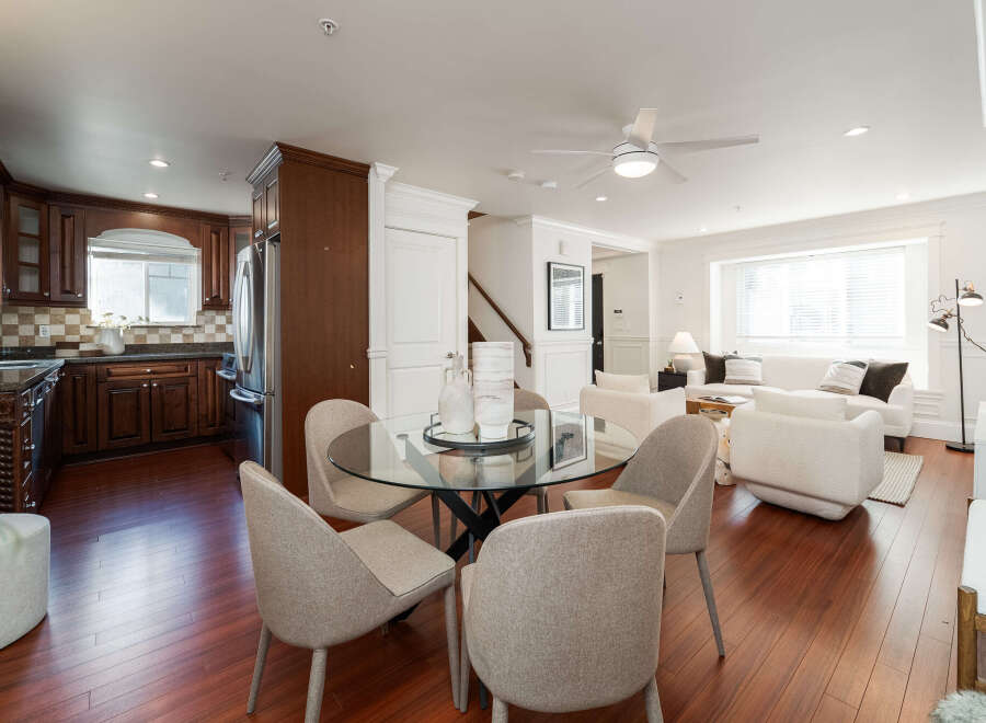 This open-concept living space seamlessly blends a modern kitchen with a comfortable dining and living area.