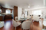This open-concept living space seamlessly blends a modern kitchen with a comfortable dining and living area.