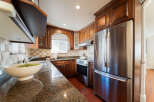 This beautifully appointed kitchen features rich, dark wood cabinetry providing ample storage and a classic aesthetic.
